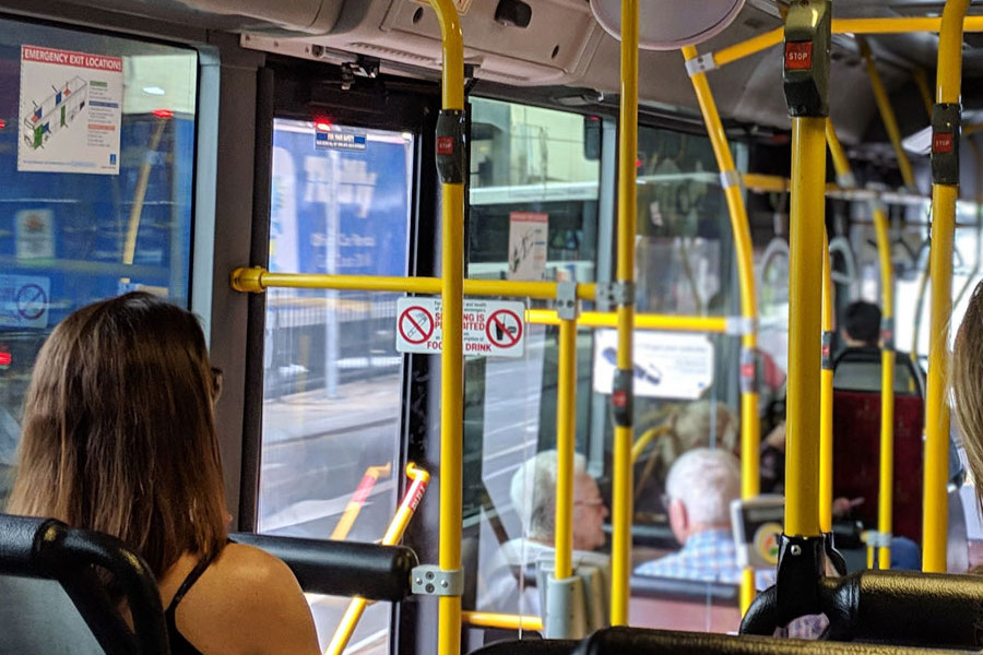Interior view of passengers in a Palm Tran bus.