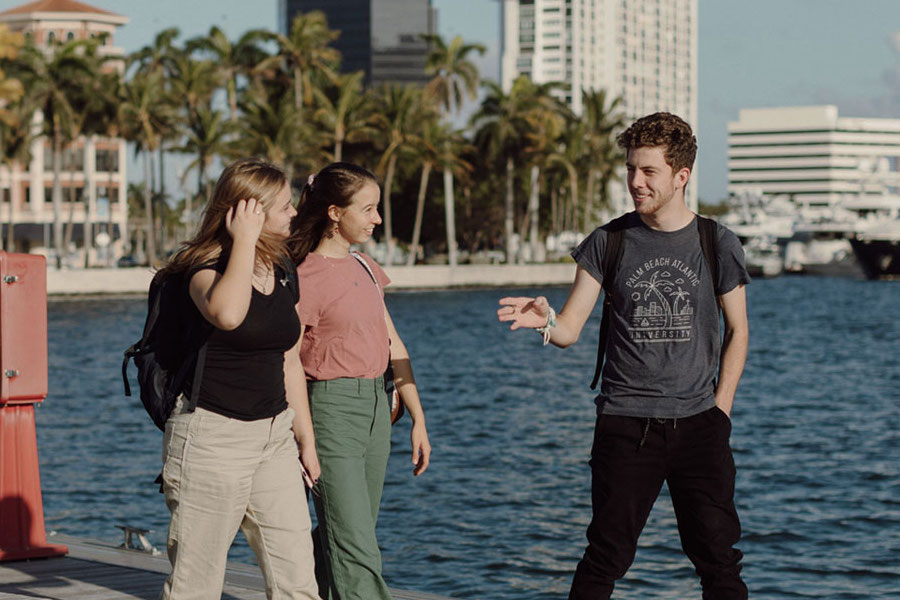 Three PBA students walking on a boardwalk.