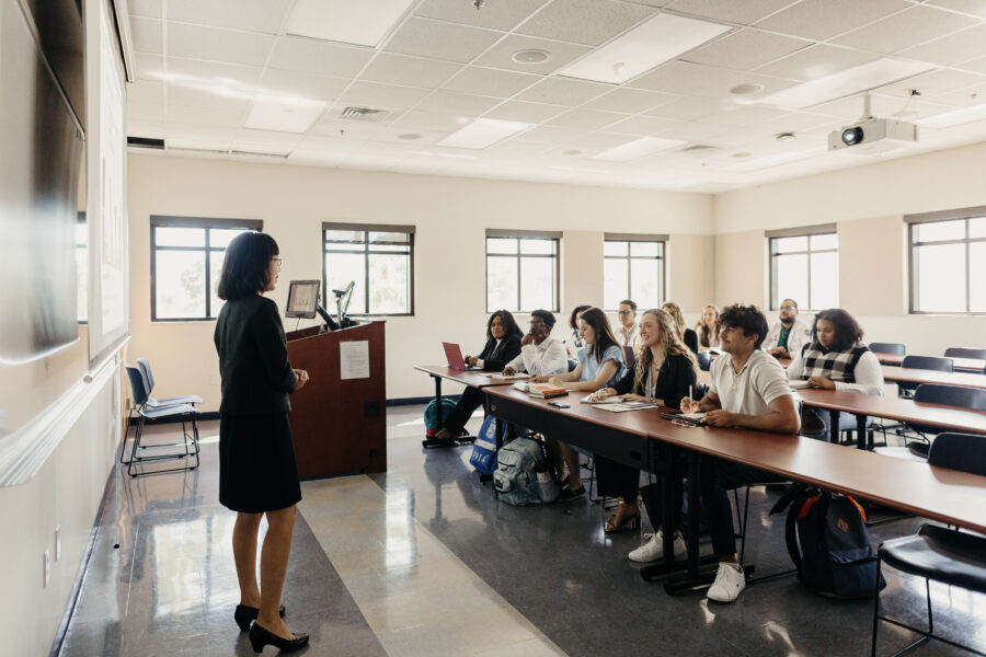 a professor speaking to a classroom full of students