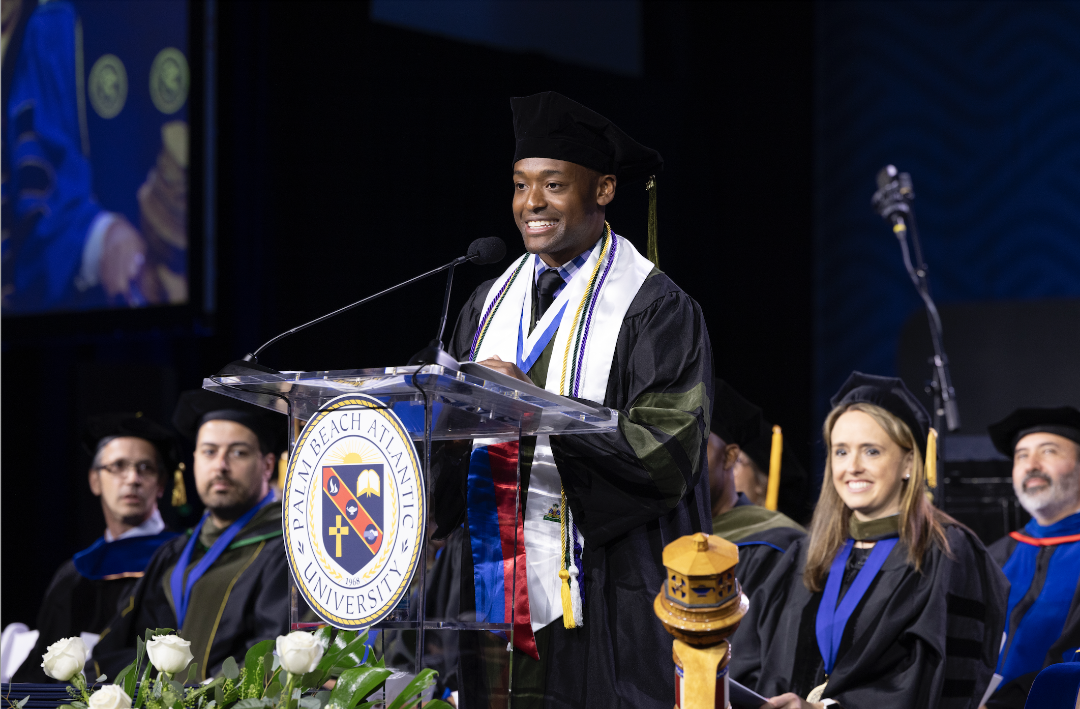 student speaking at graduation from the Professional Graduate Program
