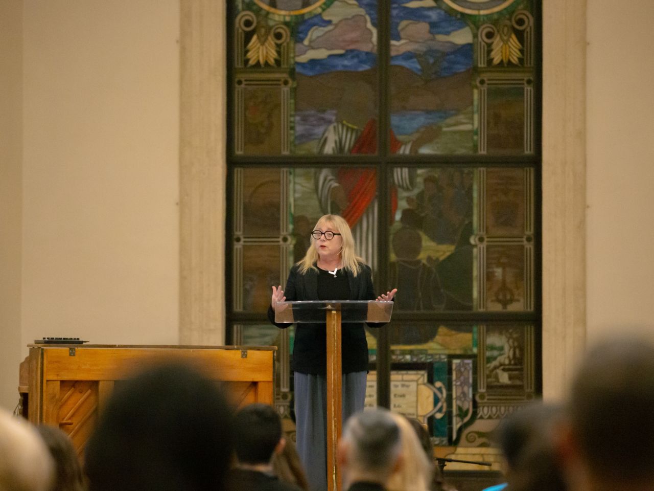A person speaking on stage at the Apologetics Conference