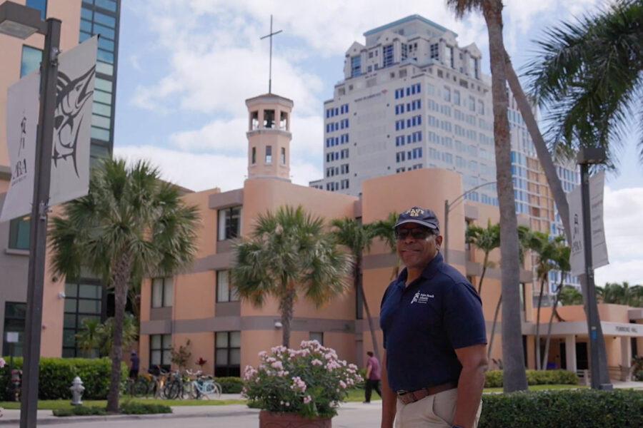 Dr. Thomas Parham stands in front of university buildings on PBA campus