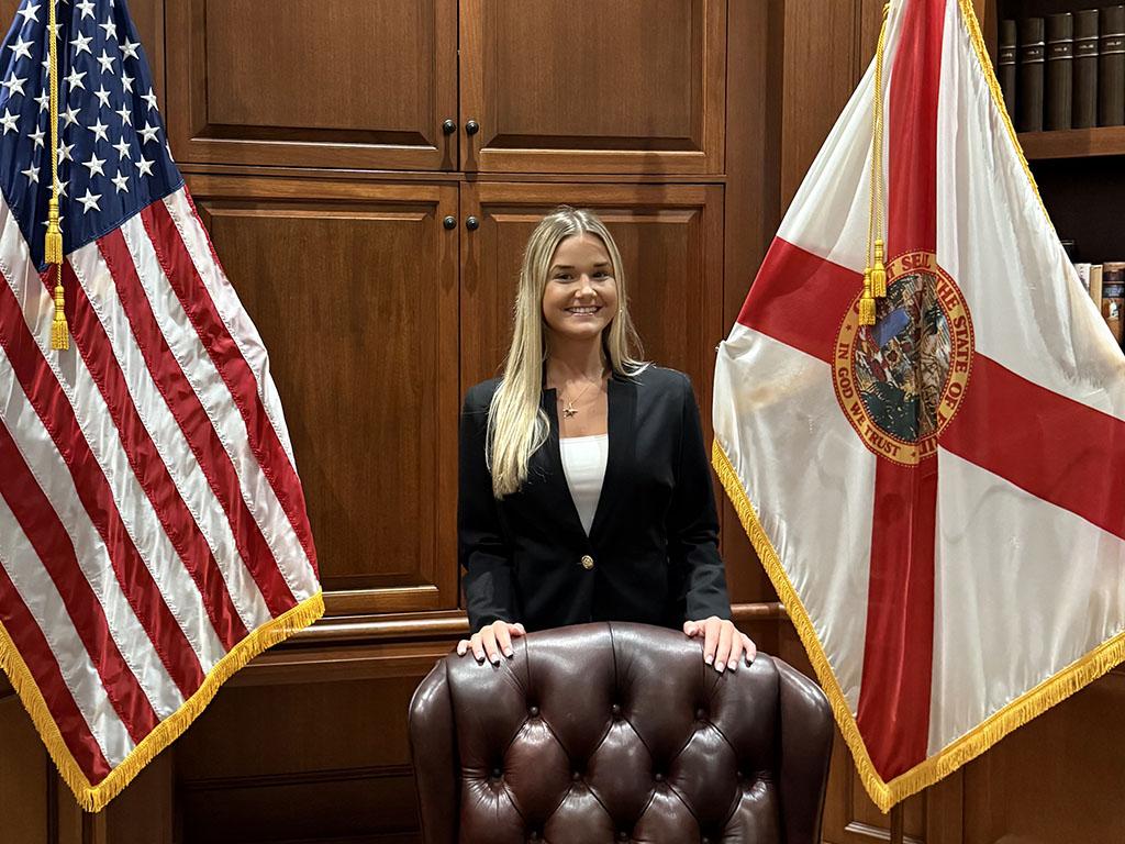Myah standing behind Governor Desantis' desk