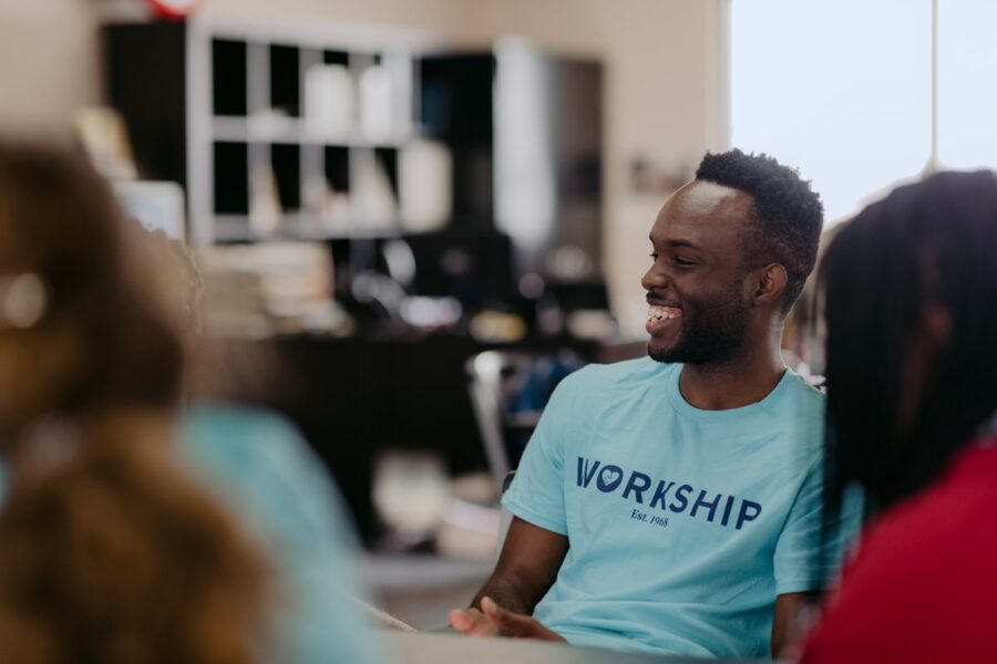 A PBA student sports a blue Workship shirt while volunteering