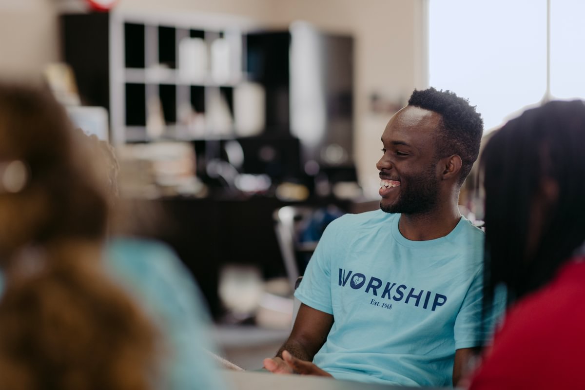 A PBA student sports a blue Workship shirt while volunteering