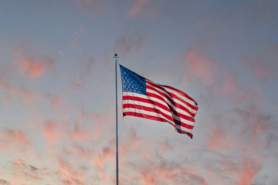 Dawn lights upon the American flag