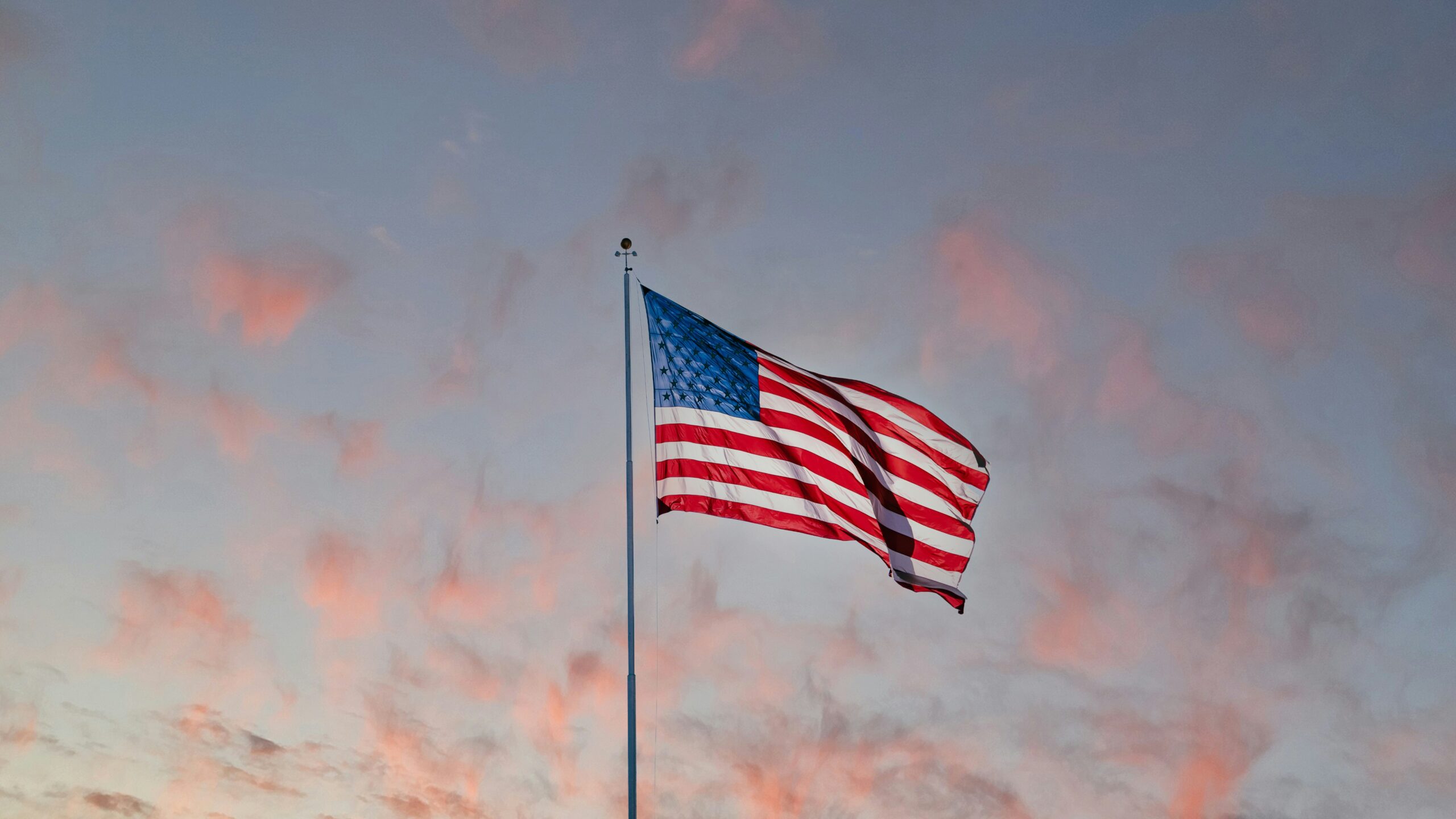 Dawn lights upon the American flag