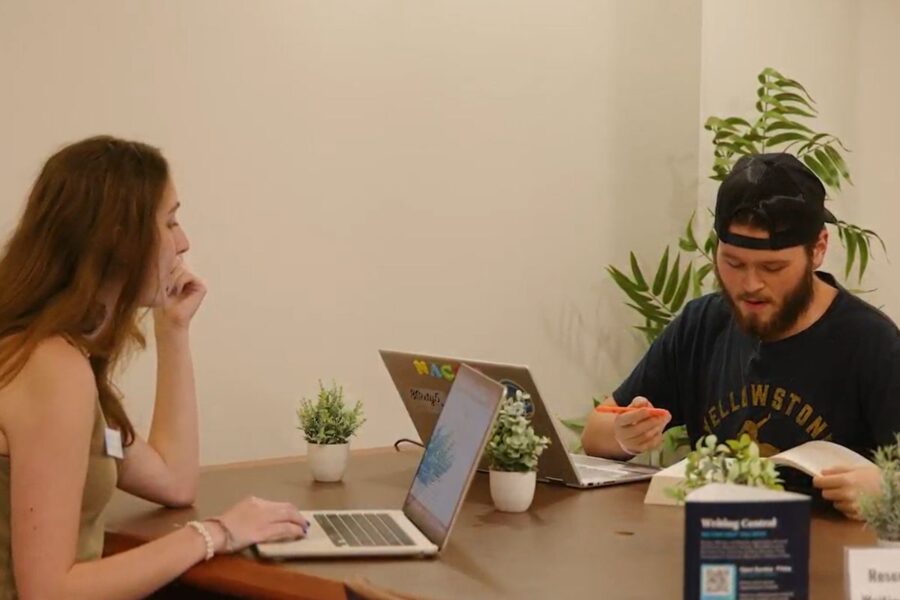 A Palm Beach Atlantic University student coaches another at the University's certified writing center.