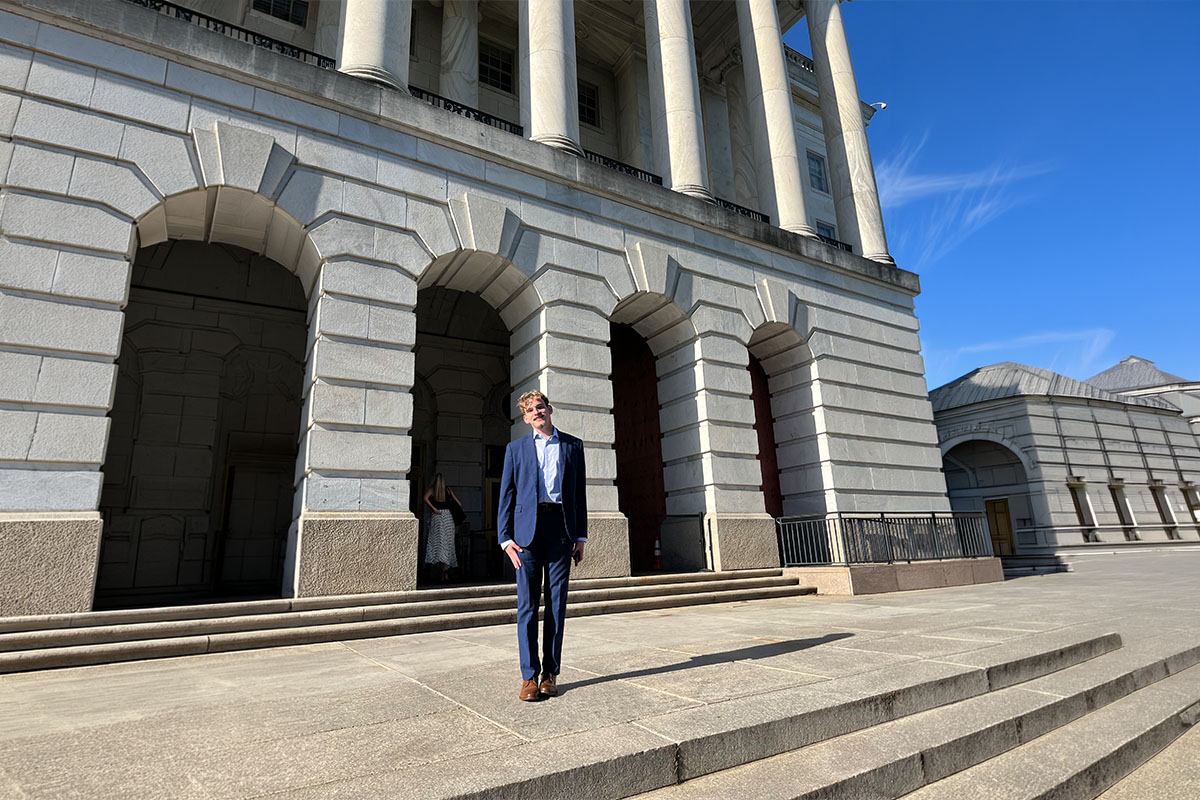 Palm Beach Atlantic University student Trent Gale stands in front of government building in Washington DC.
